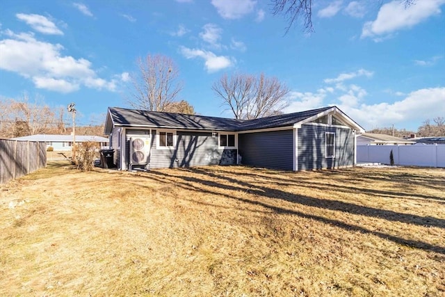 rear view of property with a yard