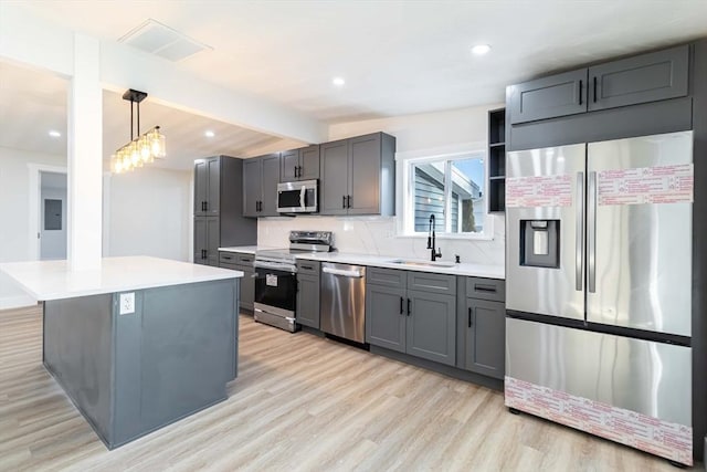 kitchen with sink, a center island, hanging light fixtures, stainless steel appliances, and vaulted ceiling with beams