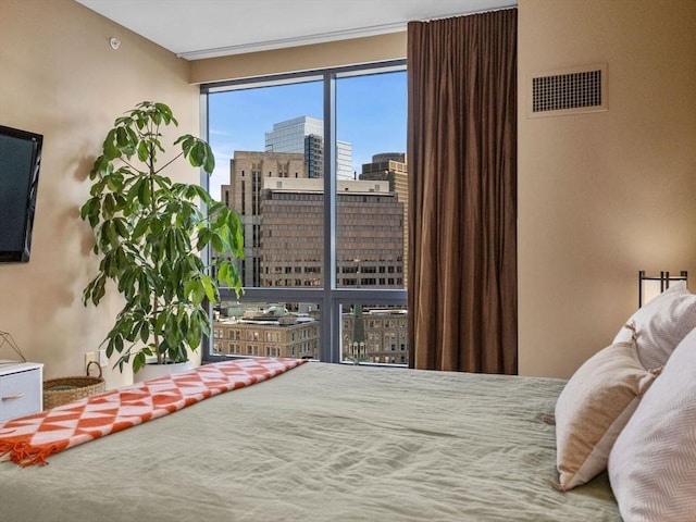 bedroom featuring a city view and visible vents