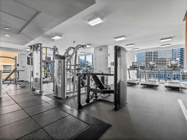 workout area featuring expansive windows and a city view