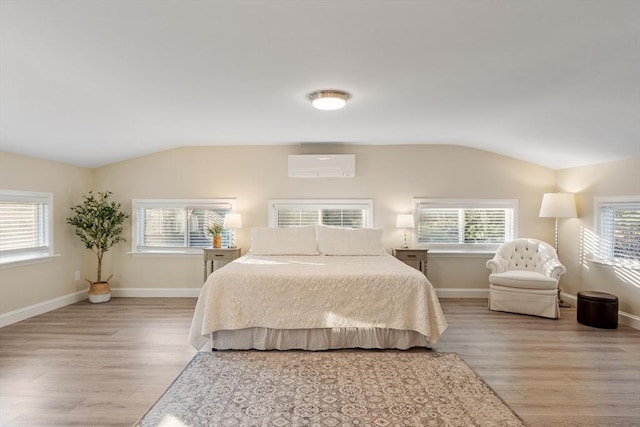 558 Amesbury Rd, Haverhill, MA 01830 - bedroom featuring lofted ceiling, light wood-style flooring, and a wall mounted AC