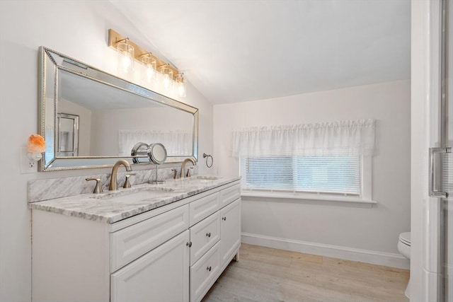 558 Amesbury Rd, Haverhill, MA 01830 - full bathroom featuring double vanity, vaulted ceiling, and wood finished floors