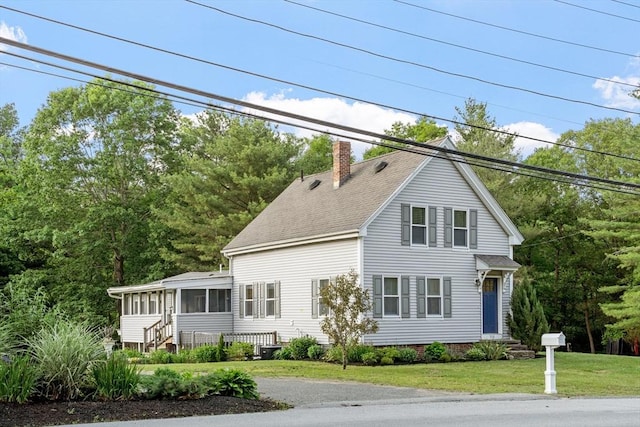 558 Amesbury Rd, Haverhill, MA 01830 - view of front of home with a chimney, a sunroom, a shingled roof, and a front yard