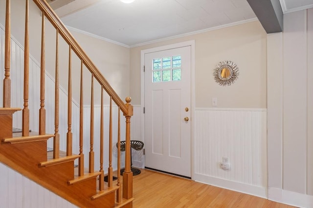 558 Amesbury Rd, Haverhill, MA 01830 - foyer entrance with light wood-type flooring, wainscoting, stairway, and ornamental molding