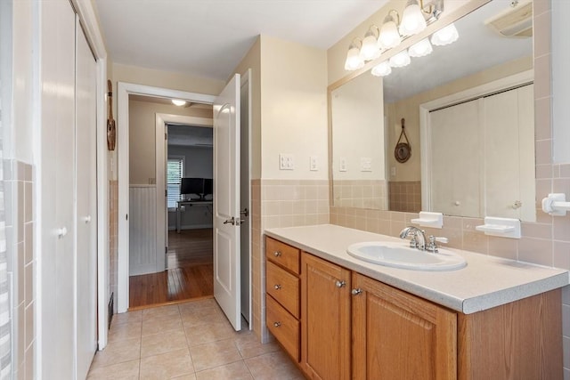558 Amesbury Rd, Haverhill, MA 01830 - bathroom with vanity, wainscoting, and tile patterned floors