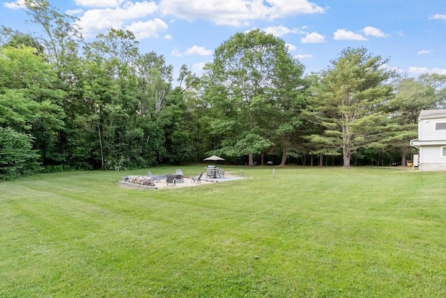 558 Amesbury Rd, Haverhill, MA 01830 - view of green lawn with an outdoor fire pit and a patio area