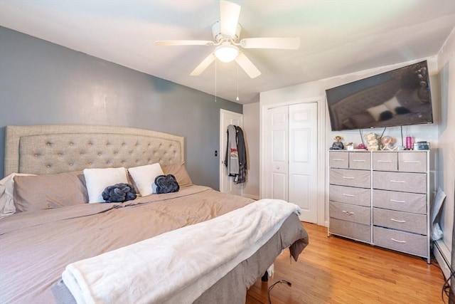 bedroom featuring light wood-style flooring, a closet, and ceiling fan