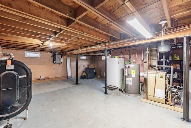 below grade area featuring electric panel, heating fuel, water heater, and a heating unit