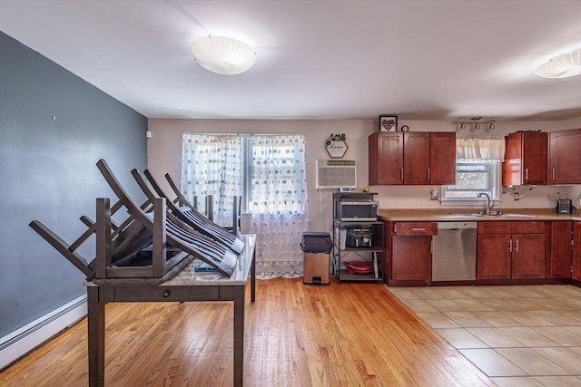 kitchen featuring light countertops, a sink, light wood-type flooring, dishwasher, and a baseboard radiator