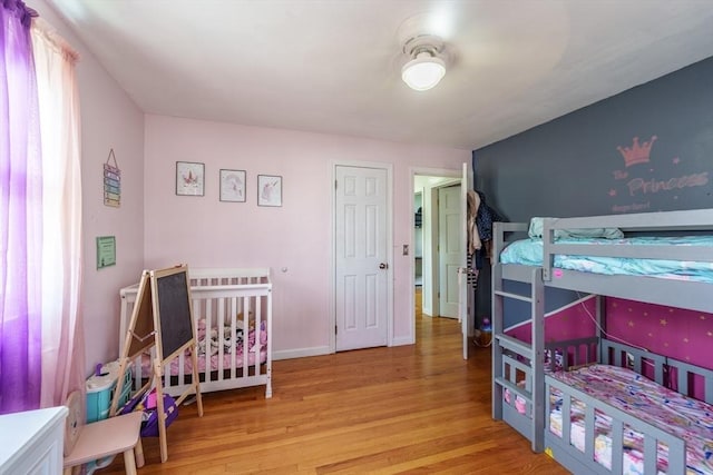 bedroom with wood finished floors and baseboards