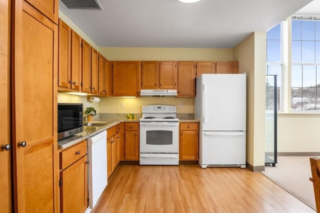 kitchen featuring sink, white appliances, and light hardwood / wood-style flooring