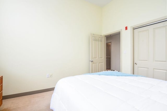 bedroom with a closet and light colored carpet