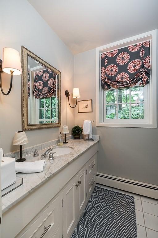4 Dexter Ln, Manchester, MA 01944 - bathroom with a baseboard radiator, vanity, and tile patterned floors