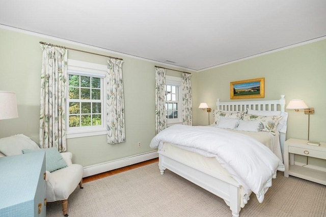 4 Dexter Ln, Manchester, MA 01944 - bedroom with multiple windows, a baseboard radiator, baseboards, and wood finished floors