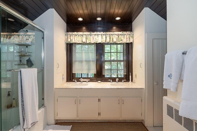 4 Dexter Ln, Manchester, MA 01944 - full bathroom with wood ceiling, double vanity, recessed lighting, radiator heating unit, and bath / shower combo with glass door