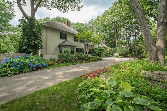 4 Dexter Ln, Manchester, MA 01944 - view of front of house with a chimney and stucco siding