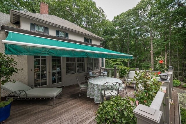 4 Dexter Ln, Manchester, MA 01944 - back of property with outdoor dining area, a deck, french doors, stucco siding, and a chimney
