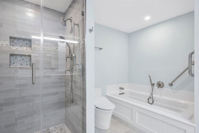 bathroom featuring tile patterned flooring, toilet, and shower with separate bathtub