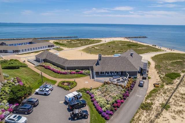 drone / aerial view featuring a water view and a view of the beach