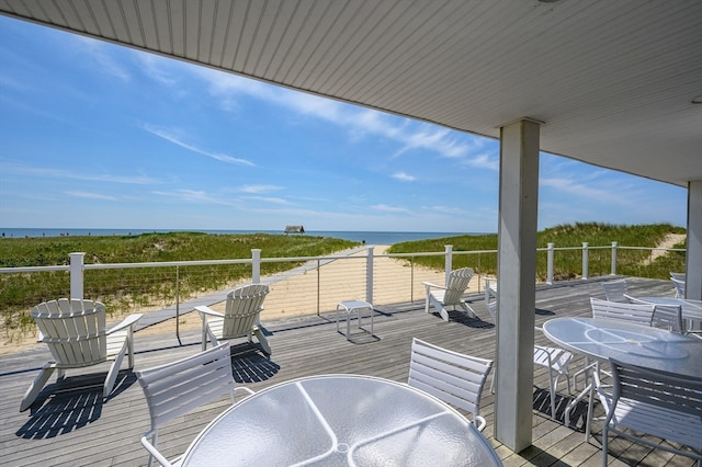 wooden terrace featuring a water view