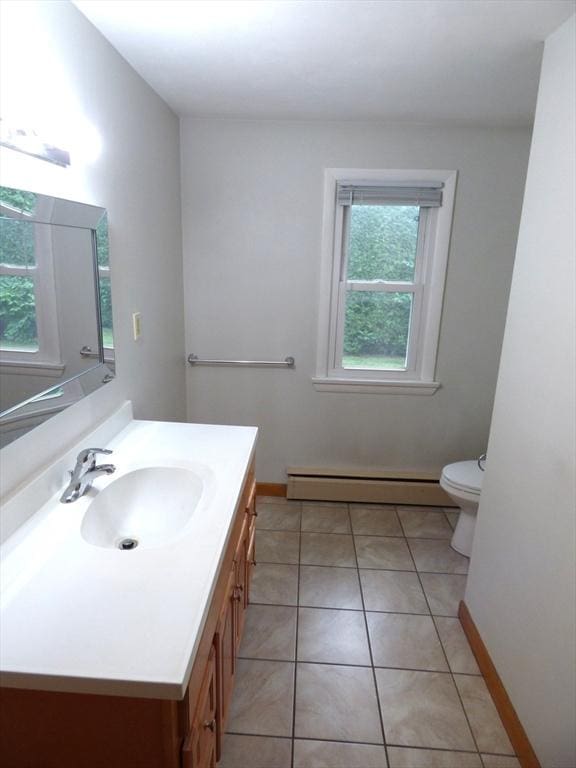 25 Williams St, Ludlow, MA 01056 - bathroom with baseboard heating, toilet, vanity, tile patterned flooring, and baseboards
