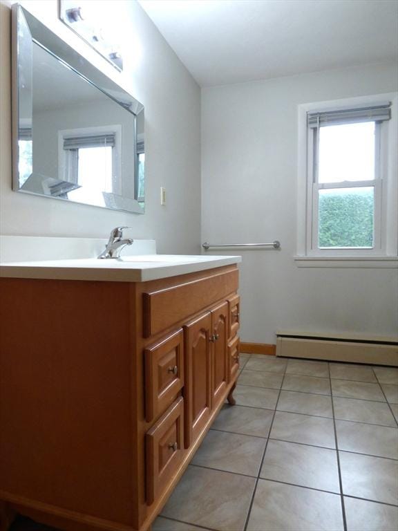 25 Williams St, Ludlow, MA 01056 - bathroom with vanity, tile patterned flooring, a baseboard heating unit, and baseboards