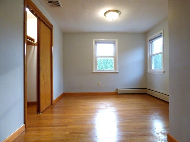25 Williams St, Ludlow, MA 01056 - unfurnished bedroom with light wood finished floors, baseboards, a baseboard radiator, and a closet