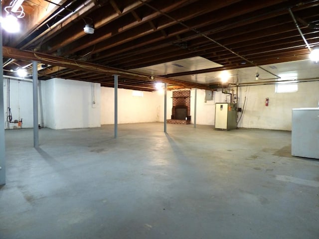 25 Williams St, Ludlow, MA 01056 - basement featuring washer / clothes dryer, a fireplace, and heating unit