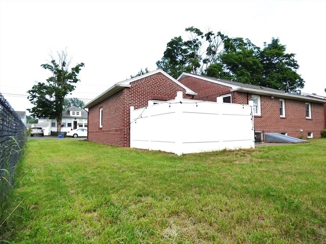 25 Williams St, Ludlow, MA 01056 - back of house featuring brick siding and central air condition unit