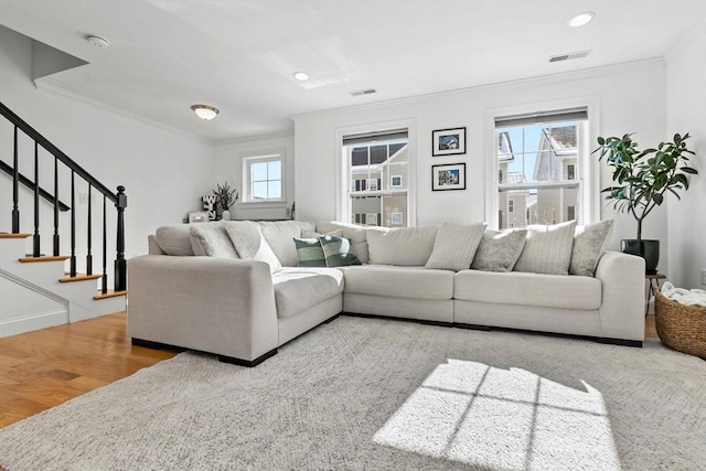 living room with hardwood / wood-style floors and crown molding