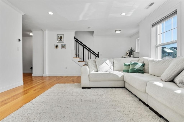 living room with hardwood / wood-style floors and crown molding