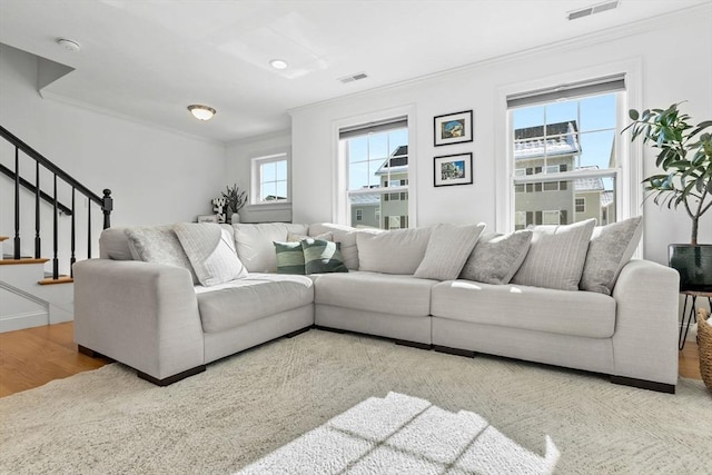 living room with hardwood / wood-style flooring and crown molding