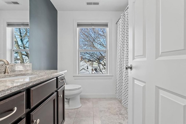 bathroom featuring toilet, vanity, and tile patterned flooring