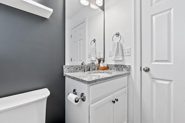 bathroom with toilet and vanity