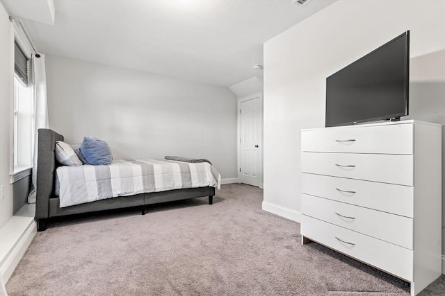 carpeted bedroom featuring lofted ceiling