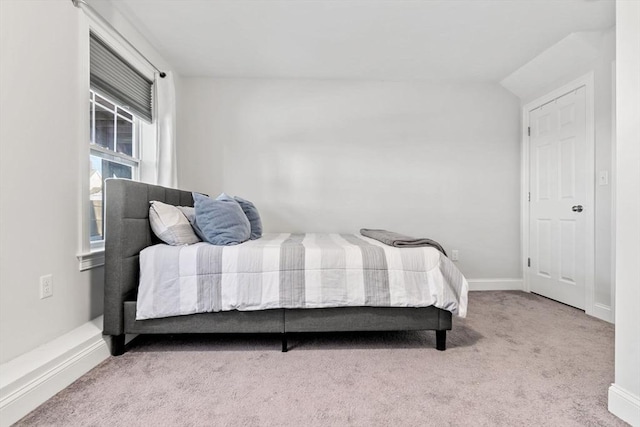 carpeted bedroom featuring lofted ceiling