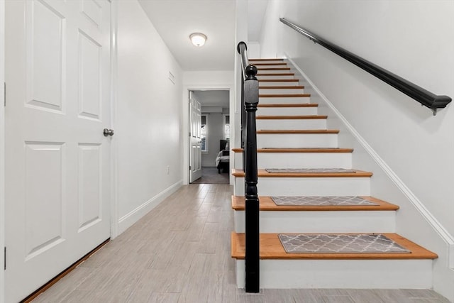 stairway featuring hardwood / wood-style floors