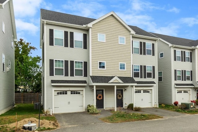 view of property with central AC unit and a garage