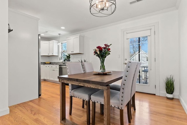 dining space with crown molding and a wealth of natural light