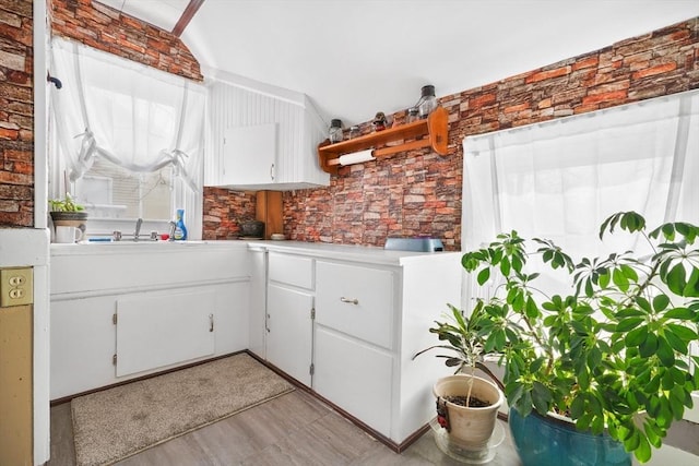 kitchen featuring sink and white cabinets