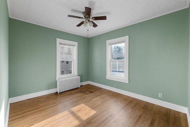 27 Cook St, Fall River, MA 02724 - spare room featuring radiator, ornamental molding, wood finished floors, and ceiling fan