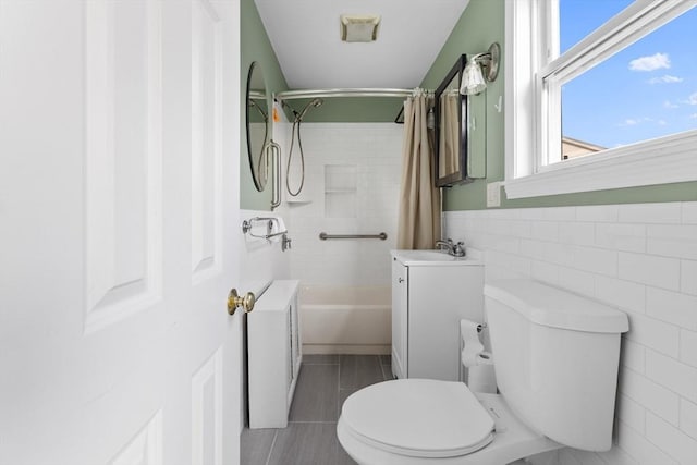 27 Cook St, Fall River, MA 02724 - bathroom with tile walls, shower / tub combo, radiator heating unit, vanity, and a wainscoted wall