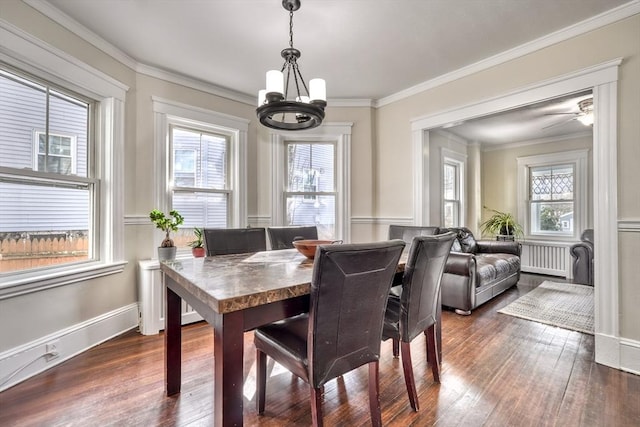 dining room with a chandelier, dark wood-style flooring, crown molding, and radiator