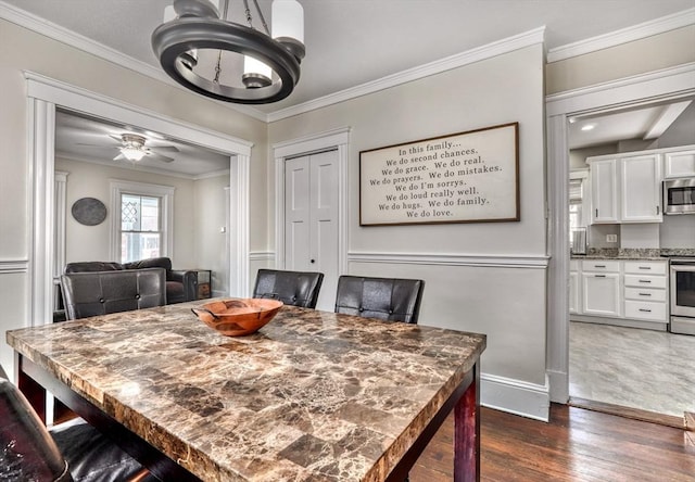 dining area with a chandelier, dark wood-style floors, ornamental molding, baseboards, and ceiling fan