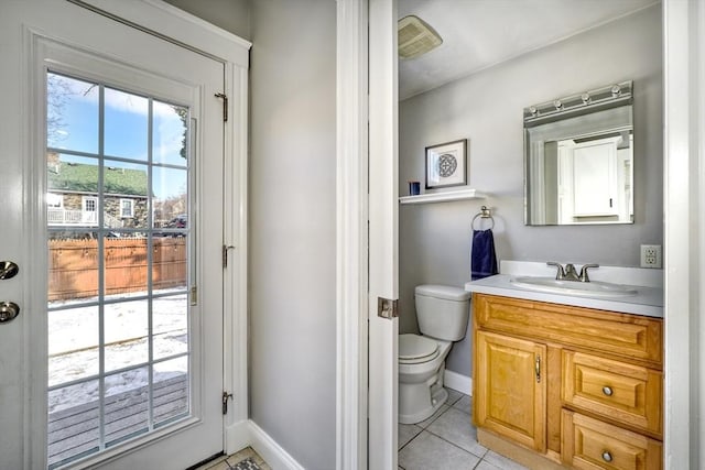 half bathroom with baseboards, toilet, tile patterned flooring, and vanity