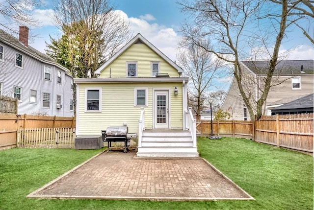 back of house featuring entry steps and a patio area