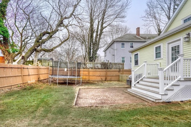 view of yard featuring a patio area and a trampoline