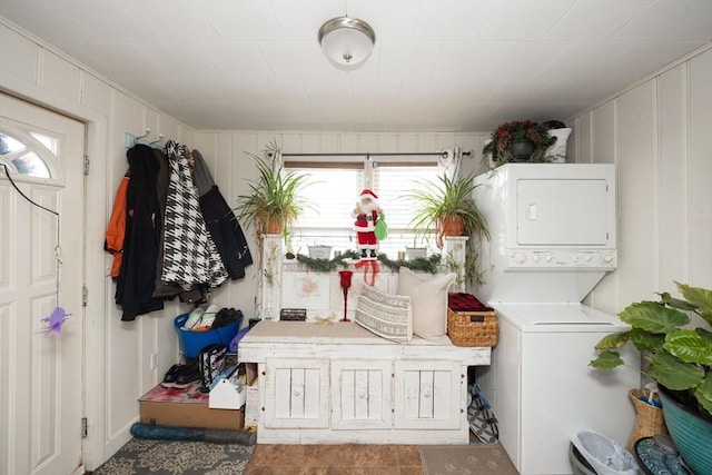 laundry area featuring stacked washer / dryer