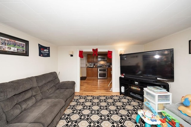 living room featuring light wood-type flooring and crown molding