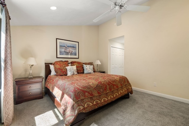 carpeted bedroom with ceiling fan, a closet, and lofted ceiling